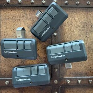 Set of 4 liftmaster remote garage door openers one doesn’t have a metal clip
